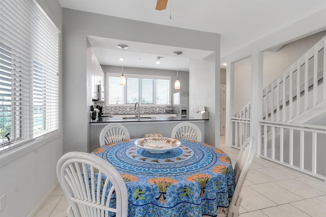 603 Cedars Ct, Longboat Key, FL 34228 - dining space with light tile patterned floors, ceiling fan, and baseboards