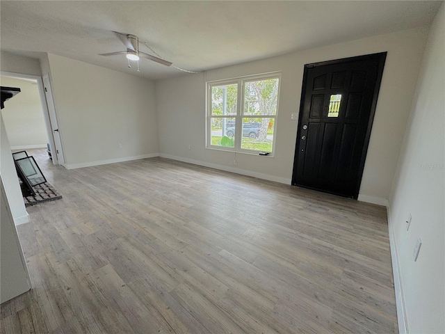 1902 24th Ave W, Bradenton, FL 34205 - foyer with a ceiling fan, light wood-style floors, baseboards, and a wood stove