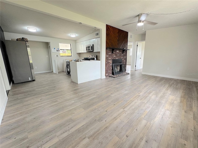 1902 24th Ave W, Bradenton, FL 34205 - unfurnished living room featuring light wood-type flooring, a ceiling fan, baseboards, and a fireplace