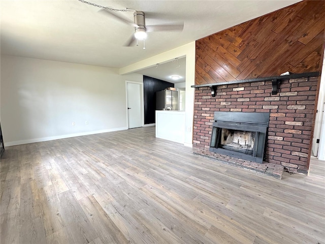 1902 24th Ave W, Bradenton, FL 34205 - unfurnished living room featuring a ceiling fan, wood finished floors, and baseboards