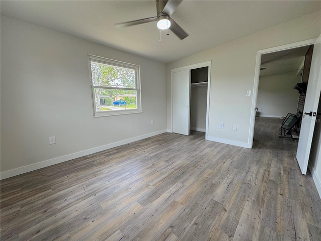 1902 24th Ave W, Bradenton, FL 34205 - unfurnished bedroom with wood finished floors, a closet, baseboards, and a ceiling fan