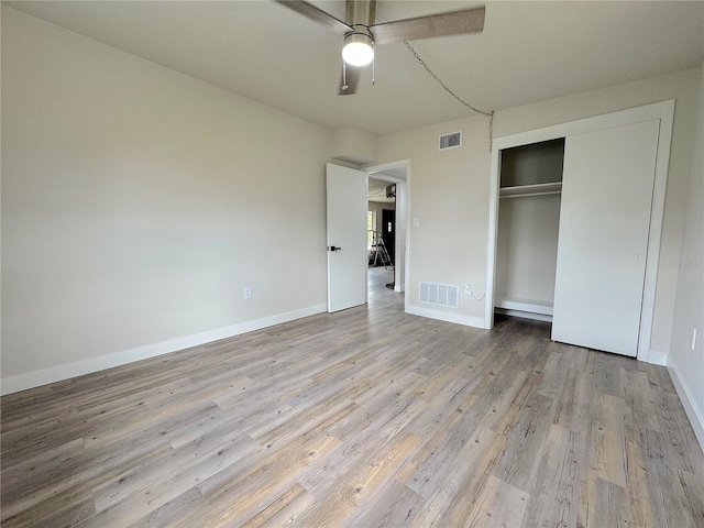 1902 24th Ave W, Bradenton, FL 34205 - unfurnished bedroom with wood finished floors, baseboards, a closet, and ceiling fan