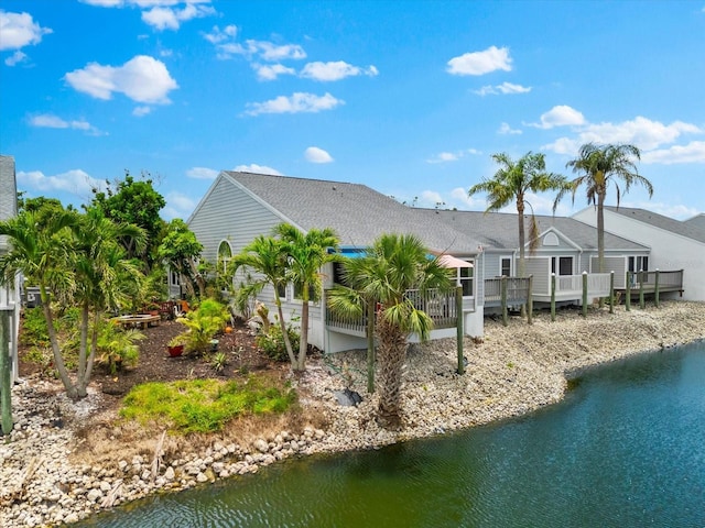 back of house featuring a deck with water view