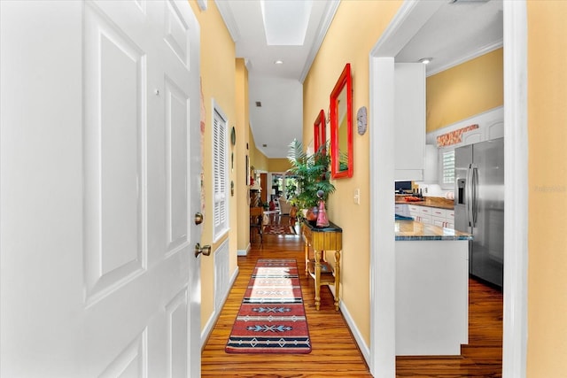 hall featuring wood finished floors and recessed lighting