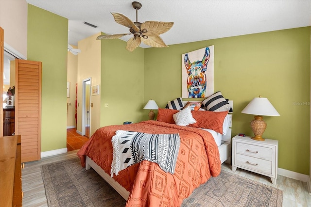 bedroom with baseboards, ceiling fan, and lofted ceiling