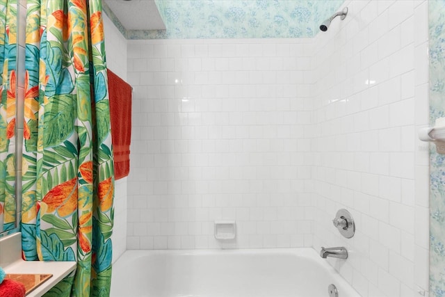full bathroom featuring wallpapered walls and shower / bathtub combination with curtain