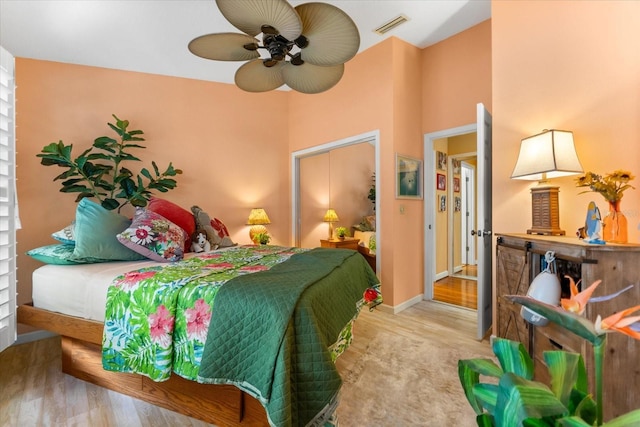 bedroom featuring wood finished floors, a ceiling fan, and baseboards