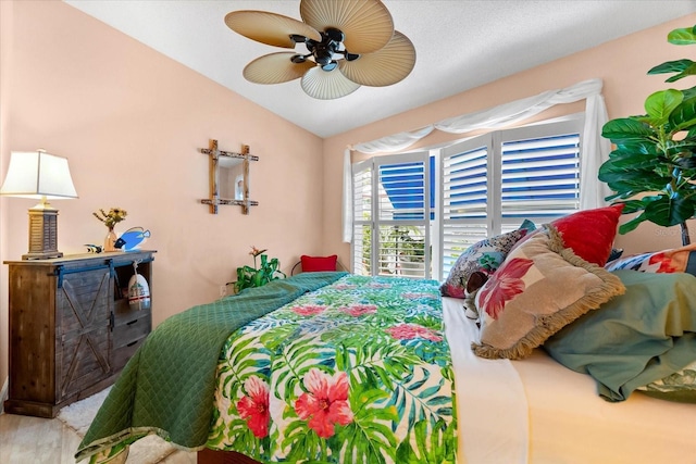 bedroom with lofted ceiling and ceiling fan