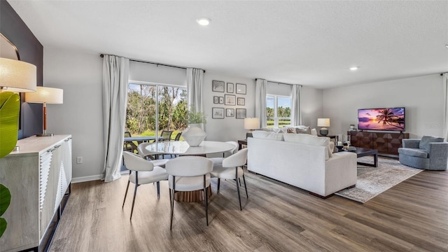 dining room featuring wood finished floors, recessed lighting, and baseboards