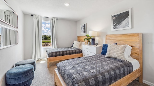 bedroom featuring carpet and baseboards