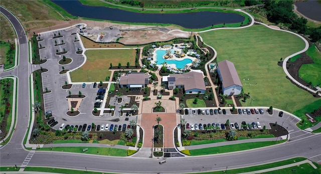 aerial overview of property's location with a nearby body of water and a pool
