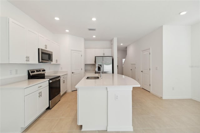9064 Driven Snow St, Sarasota, FL 34241 - kitchen with stainless steel appliances, a sink, light tile patterned floors, white cabinetry, and recessed lighting