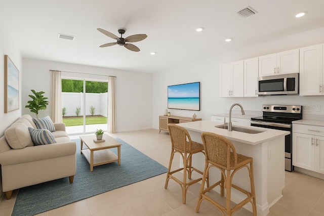 9064 Driven Snow St, Sarasota, FL 34241 - kitchen with stainless steel appliances, open floor plan, a sink, ceiling fan, and white cabinets