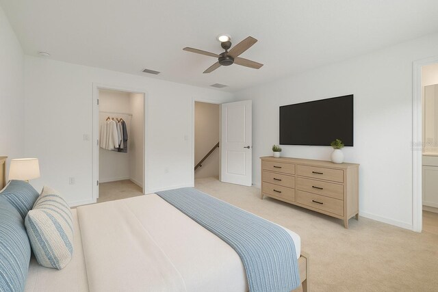 9064 Driven Snow St, Sarasota, FL 34241 - bedroom featuring light colored carpet, a walk in closet, a ceiling fan, ensuite bath, and a closet