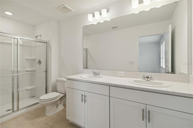 9064 Driven Snow St, Sarasota, FL 34241 - full bathroom with double vanity, toilet, tile patterned flooring, and a stall shower