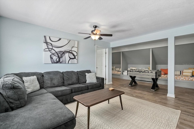 4708 26th Ave W, Bradenton, FL 34209 - living area featuring wood finished floors, a ceiling fan, baseboards, and a textured ceiling