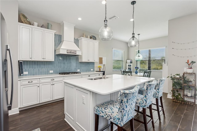 13708 Old Creek Ct, Parrish, FL 34219 - kitchen featuring a sink, custom range hood, light countertops, dark wood-style floors, and tasteful backsplash