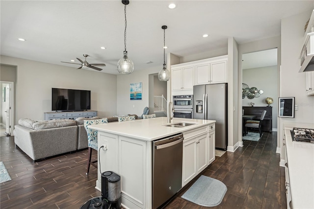13708 Old Creek Ct, Parrish, FL 34219 - kitchen with appliances with stainless steel finishes, a sink, dark wood finished floors, recessed lighting, and white cabinets