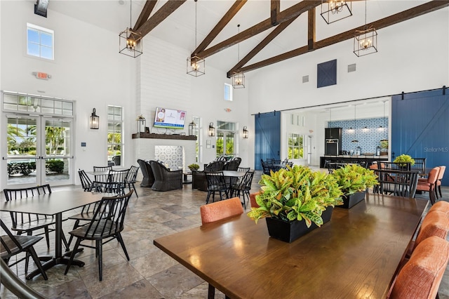 13708 Old Creek Ct, Parrish, FL 34219 - dining area with high vaulted ceiling, beam ceiling, and a brick fireplace