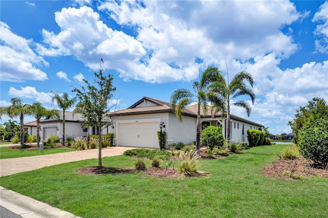 17725 Northwood Pl, Bradenton, FL 34202 - ranch-style home with stucco siding, decorative driveway, an attached garage, and a front yard