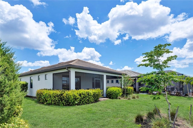 17725 Northwood Pl, Bradenton, FL 34202 - rear view of property with a yard and stucco siding