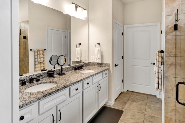 17725 Northwood Pl, Bradenton, FL 34202 - bathroom featuring tile patterned flooring, double vanity, and a tile shower