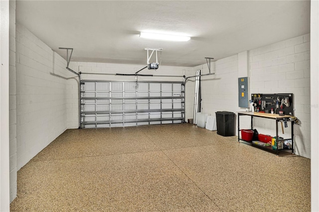 17725 Northwood Pl, Bradenton, FL 34202 - garage featuring a garage door opener, electric panel, and concrete block wall