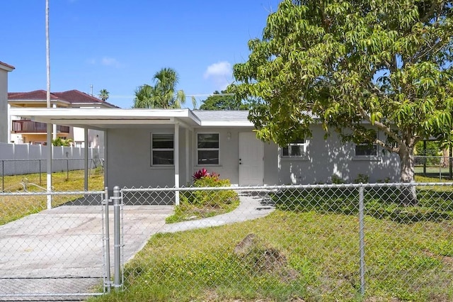 2739 Palmadelia Ave, Sarasota, FL 34234 - view of front facade with an attached carport, stucco siding, and a gate