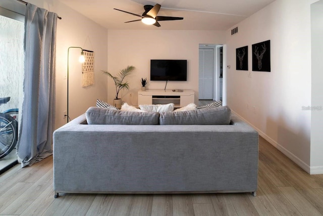 6157 Midnight Pass Rd Unit E73, Sarasota, FL 34242 - living area featuring light wood finished floors, ceiling fan, and baseboards