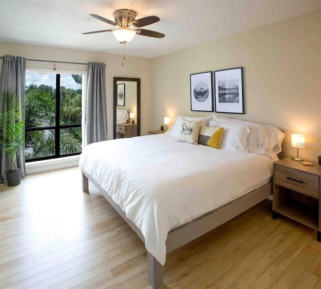 6157 Midnight Pass Rd Unit E73, Sarasota, FL 34242 - bedroom featuring light wood-style flooring and a ceiling fan