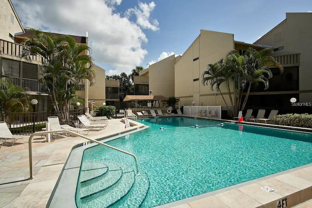 6157 Midnight Pass Rd Unit E73, Sarasota, FL 34242 - community pool featuring a patio and fence