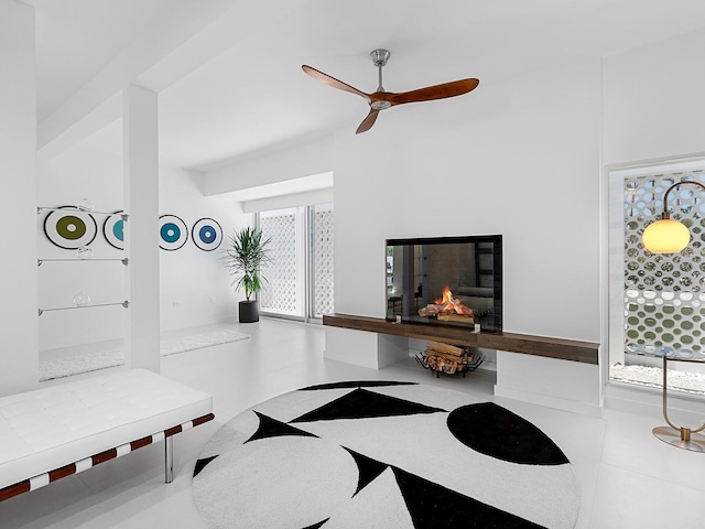 7647 Sanderling Rd, Sarasota, FL 34242 - living area featuring ceiling fan and a warm lit fireplace