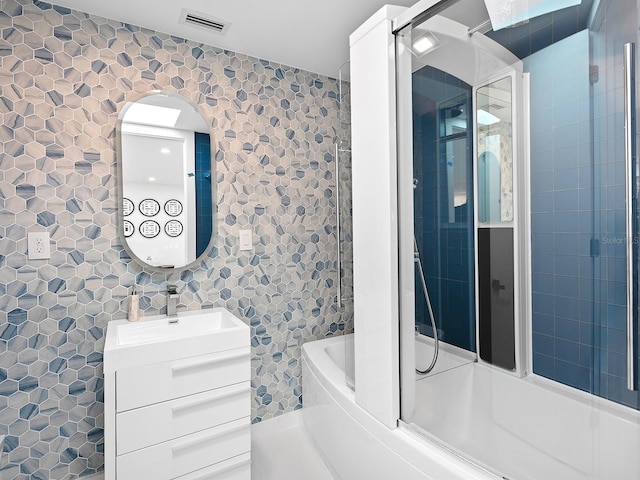 7647 Sanderling Rd, Sarasota, FL 34242 - bathroom with vanity, enclosed tub / shower combo, and tile walls