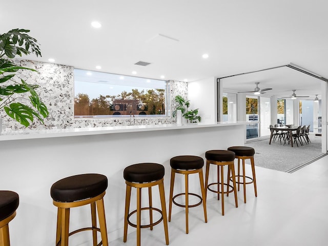 7647 Sanderling Rd, Sarasota, FL 34242 - kitchen with a kitchen bar, recessed lighting, and a ceiling fan
