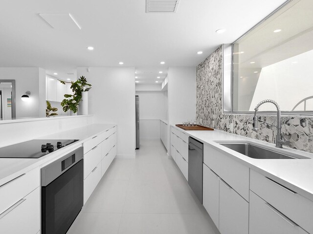 7647 Sanderling Rd, Sarasota, FL 34242 - kitchen featuring a sink, modern cabinets, wall oven, stainless steel dishwasher, and recessed lighting