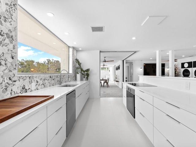 7647 Sanderling Rd, Sarasota, FL 34242 - kitchen featuring modern cabinets, a sink, stainless steel appliances, ceiling fan, and white cabinetry