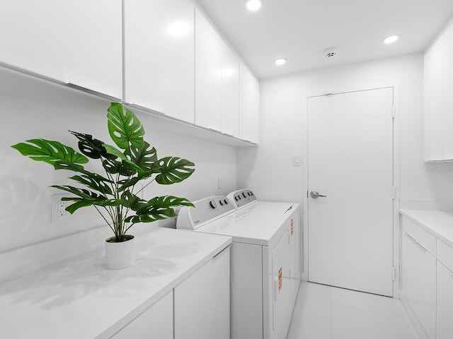 7647 Sanderling Rd, Sarasota, FL 34242 - washroom featuring independent washer and dryer, cabinet space, recessed lighting, and light tile patterned flooring