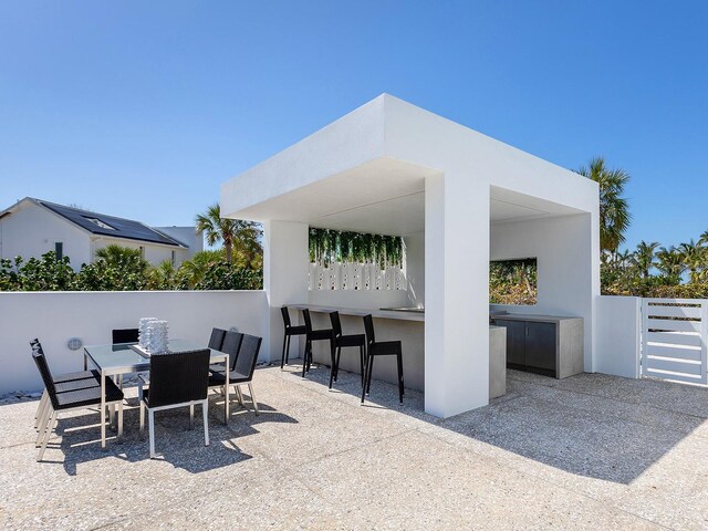 7647 Sanderling Rd, Sarasota, FL 34242 - view of patio featuring an outdoor bar