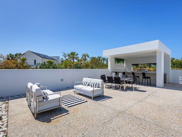 7647 Sanderling Rd, Sarasota, FL 34242 - view of patio / terrace with an outdoor living space