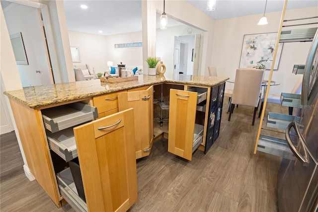 2419 Riverbluff Pkwy Unit V233, Sarasota, FL 34231 - kitchen with dark wood finished floors, light stone countertops, and hanging light fixtures