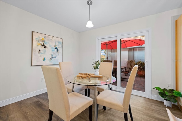 2419 Riverbluff Pkwy Unit V233, Sarasota, FL 34231 - dining room with baseboards and wood finished floors