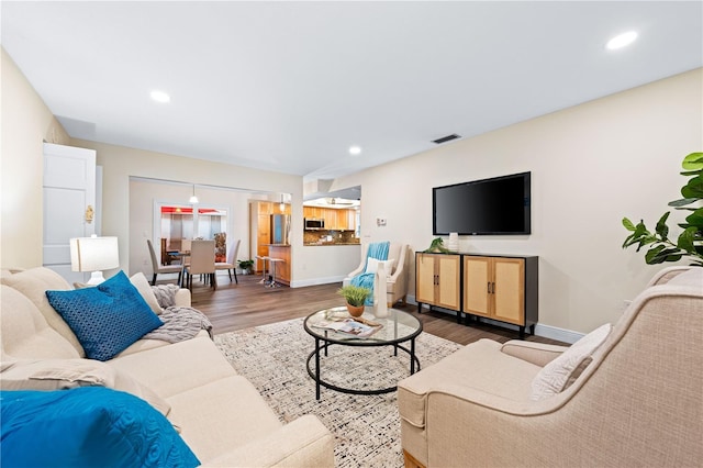 2419 Riverbluff Pkwy Unit V233, Sarasota, FL 34231 - living area with wood finished floors, baseboards, and recessed lighting