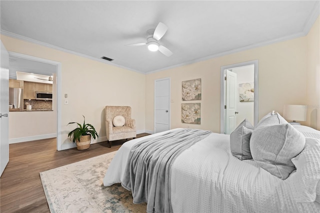 2419 Riverbluff Pkwy Unit V233, Sarasota, FL 34231 - bedroom with wood finished floors, baseboards, ornamental molding, refrigerator, and a ceiling fan