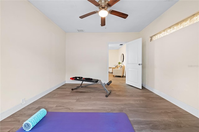 2419 Riverbluff Pkwy Unit V233, Sarasota, FL 34231 - workout room with ceiling fan, wood finished floors, and baseboards