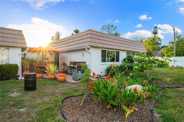 2419 Riverbluff Pkwy Unit V233, Sarasota, FL 34231 - rear view of house featuring mansard roof and stucco siding