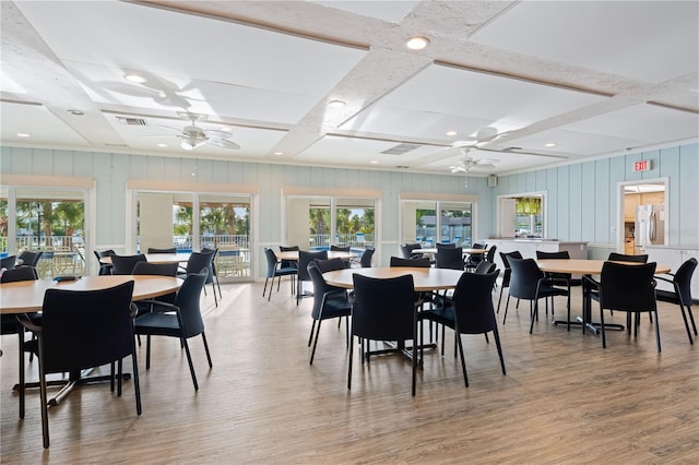 2419 Riverbluff Pkwy Unit V233, Sarasota, FL 34231 - dining area featuring ceiling fan, plenty of natural light, beamed ceiling, coffered ceiling, and a decorative wall