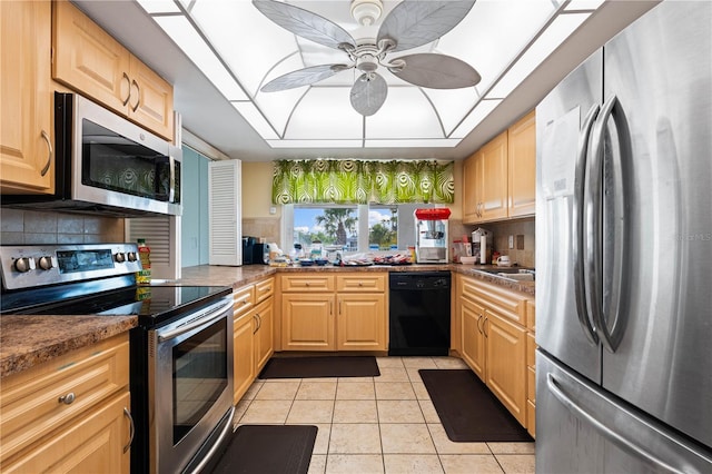 2419 Riverbluff Pkwy Unit V233, Sarasota, FL 34231 - kitchen with stainless steel appliances, light tile patterned floors, and tasteful backsplash