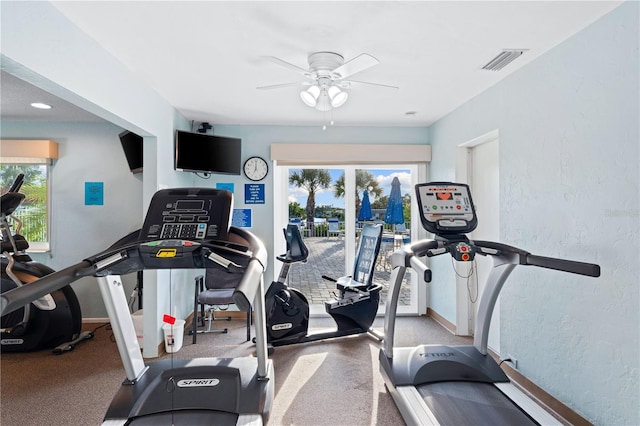 2419 Riverbluff Pkwy Unit V233, Sarasota, FL 34231 - workout area with a ceiling fan, baseboards, and a textured wall