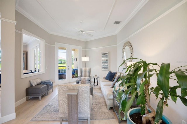 7164 Rue De Palisades Unit 5, Sarasota, FL 34238 - living room with french doors, light wood finished floors, ceiling fan, ornamental molding, and baseboards