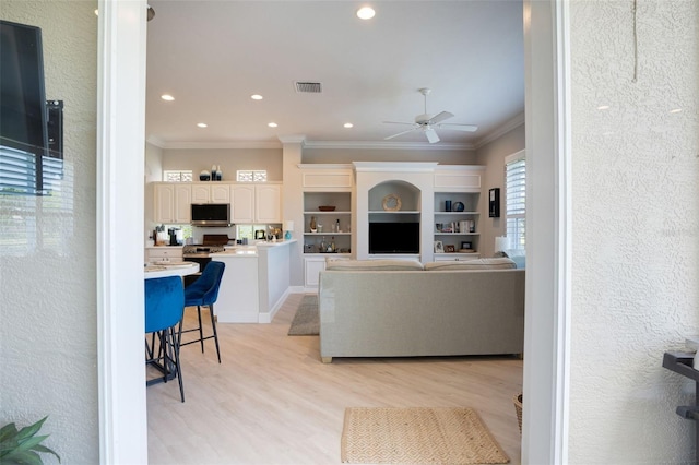 7164 Rue De Palisades Unit 5, Sarasota, FL 34238 - living room featuring ornamental molding, a ceiling fan, light wood-style flooring, and recessed lighting